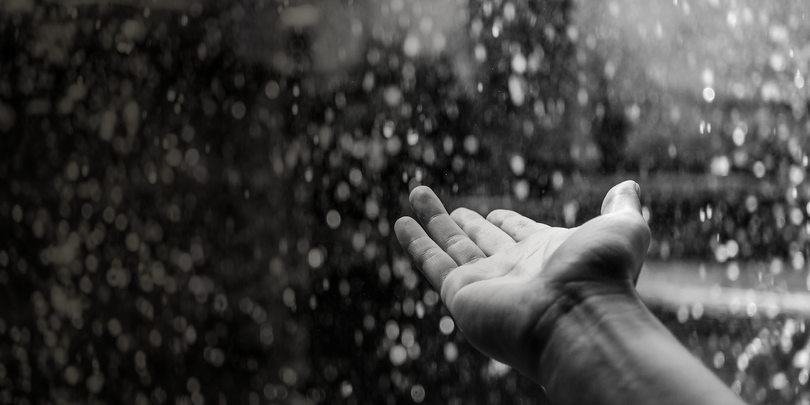 Outstretched hand in the rain - touch a life and touch the future