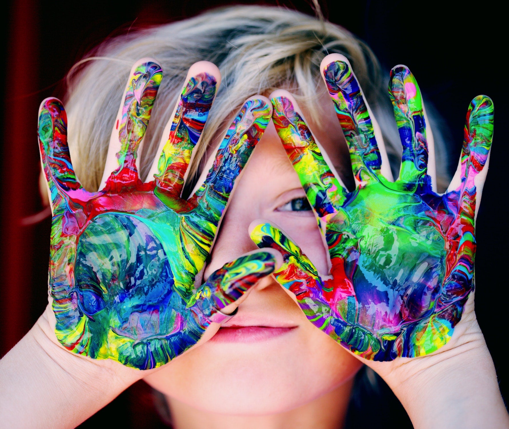 Happy, creative boy with paint on his hands