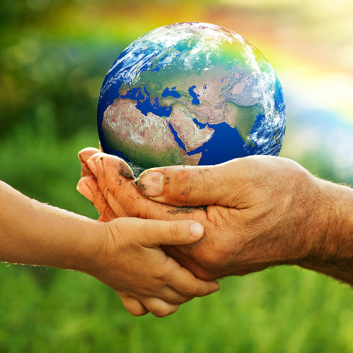 Child and adult hands holding our planet -  Caring for Mother Earth
